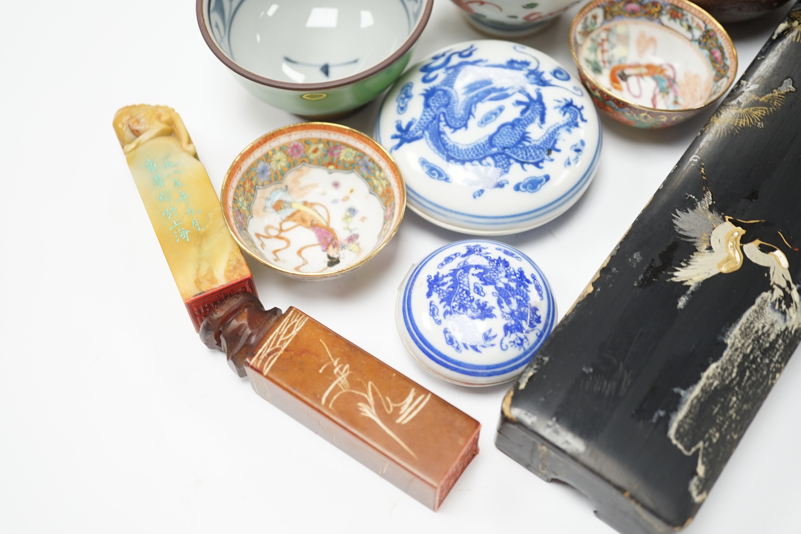 A group of Chinese and Japanese ceramics and works of art including two carved seals and tea bowls housed in a red lacquered box